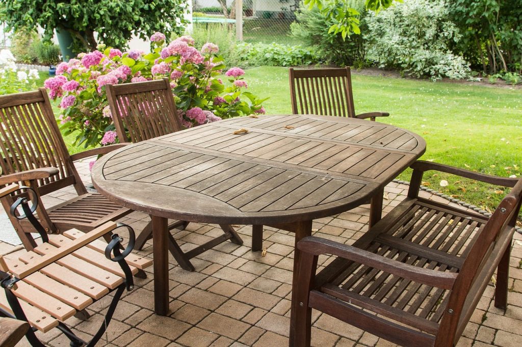 garden furniture on a patio that needs a clean